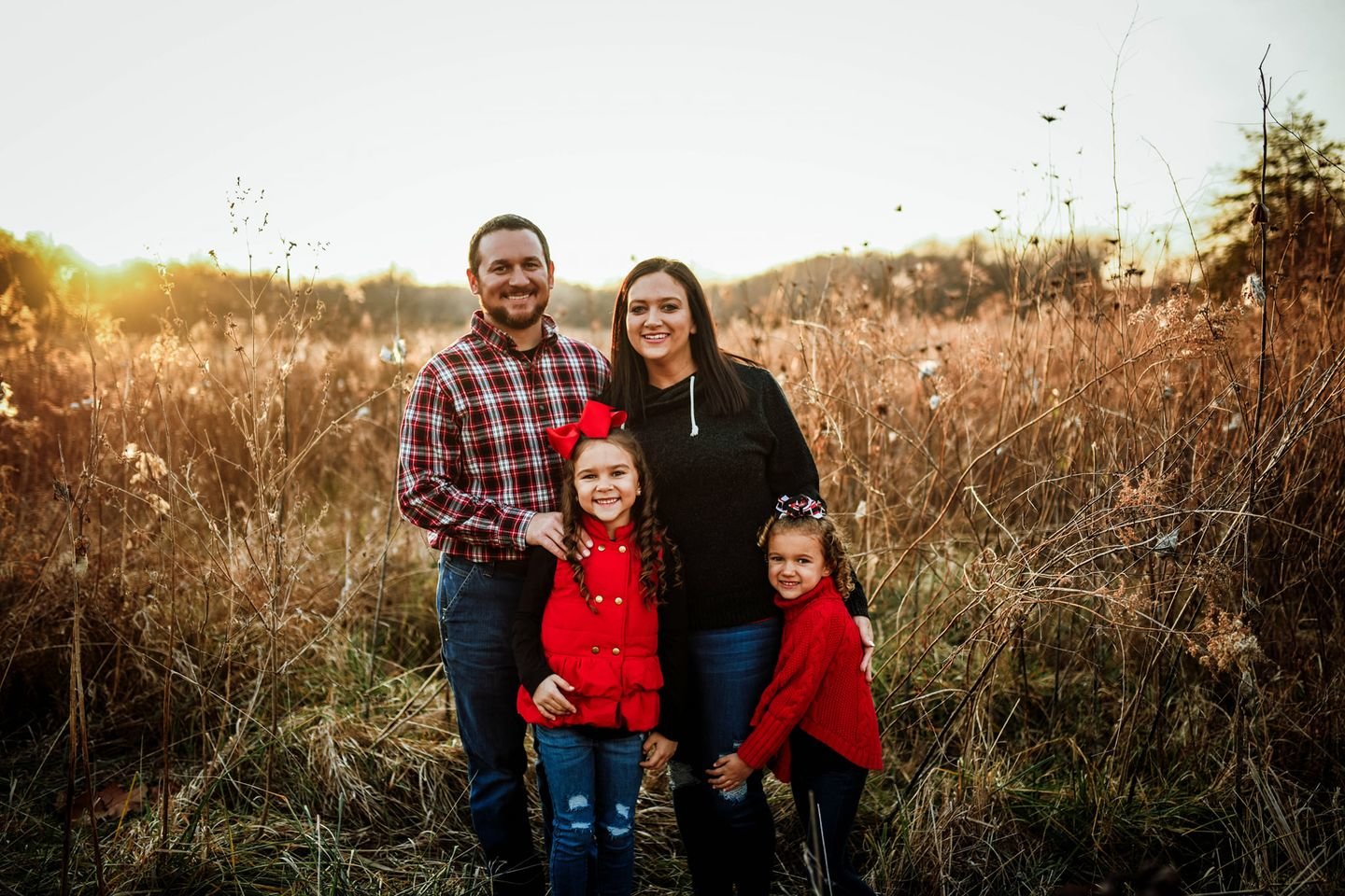 Georgia Hearn, program director for Anne’s Anchor in Bowling Green, her husband, Cody, and their daughters pose for a family photo.